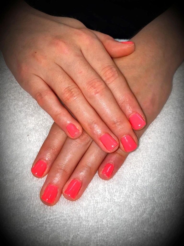 Deep pink gel polish on short nails
